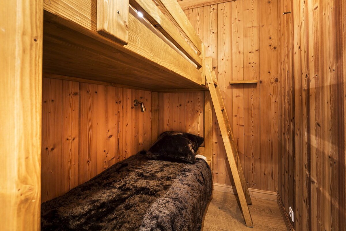 A bedroom with a painting of a wolf on the wall