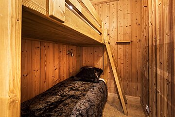 A bedroom with a painting of a wolf on the wall