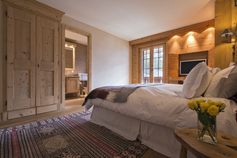 A bedroom with a large bed and a television