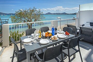 A table with plates and a bottle of wine on it