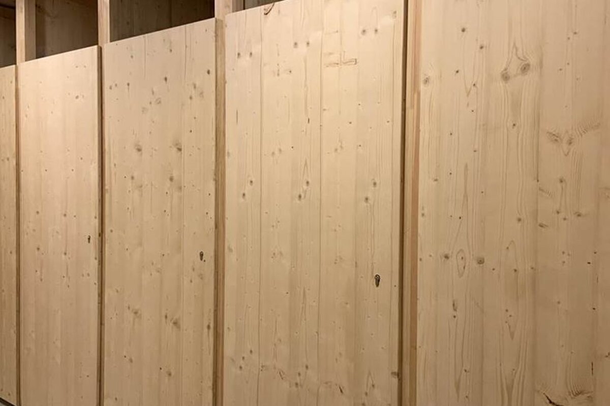 A wooden wall with a few holes in it