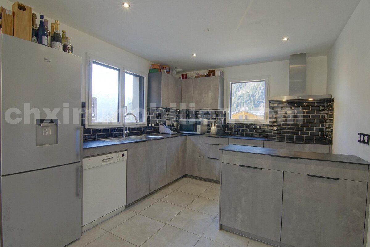 A kitchen with a beko refrigerator and a dishwasher