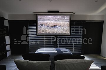 A projector screen shows a picture of deer in a field