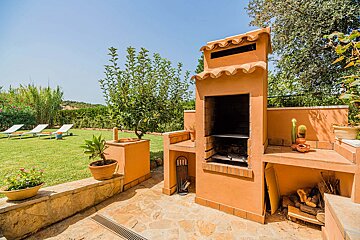 A brick bbq with a chimney on top of it