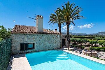 A house with a swimming pool in front of it