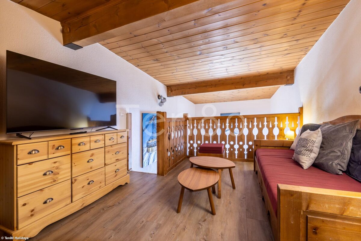A living room with a couch and a flat screen tv