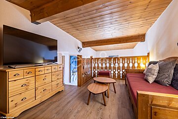 A living room with a couch and a flat screen tv