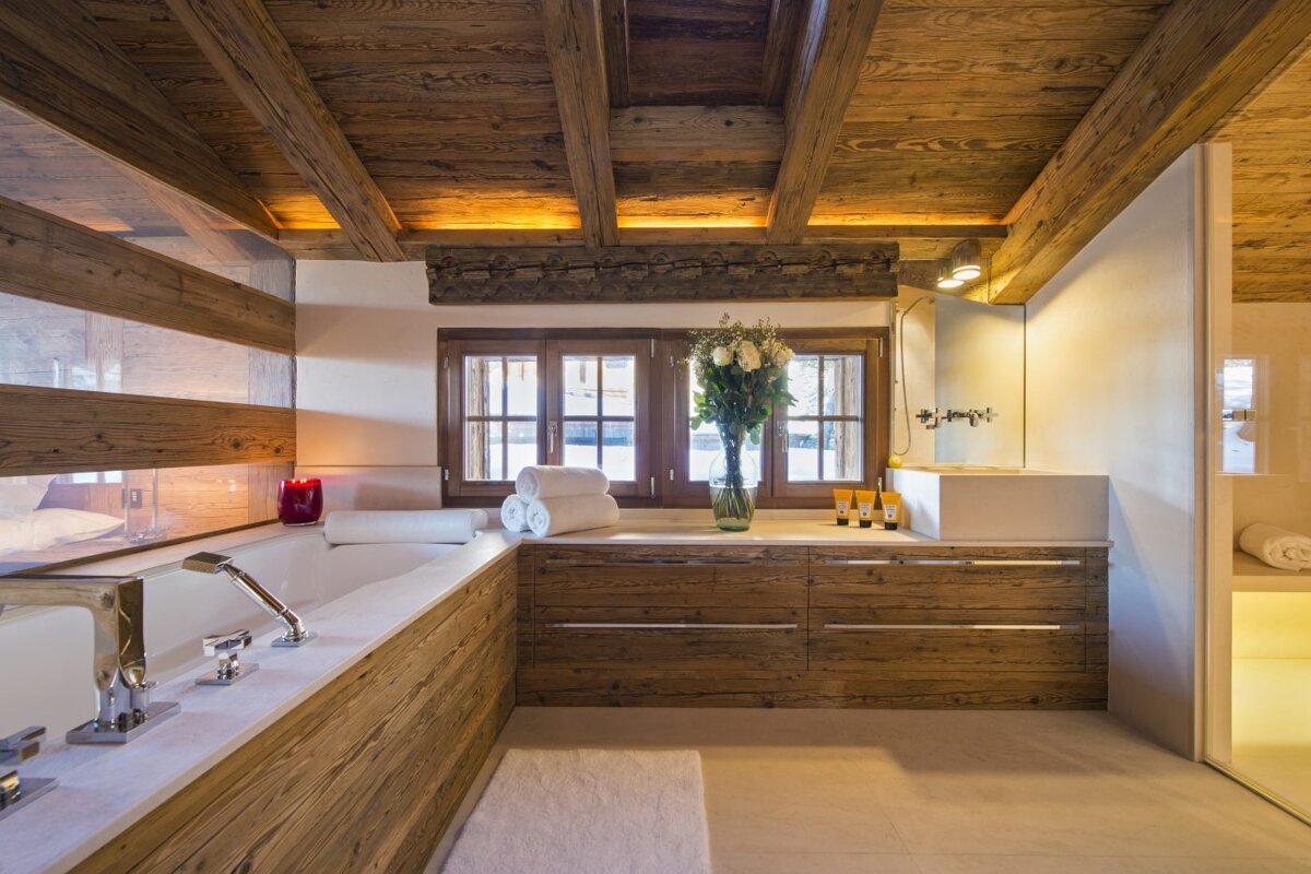 A bathroom with wooden cabinets and a sink