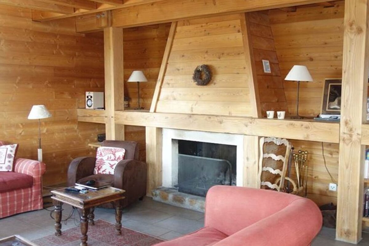A living room with a fireplace and a couch and chair