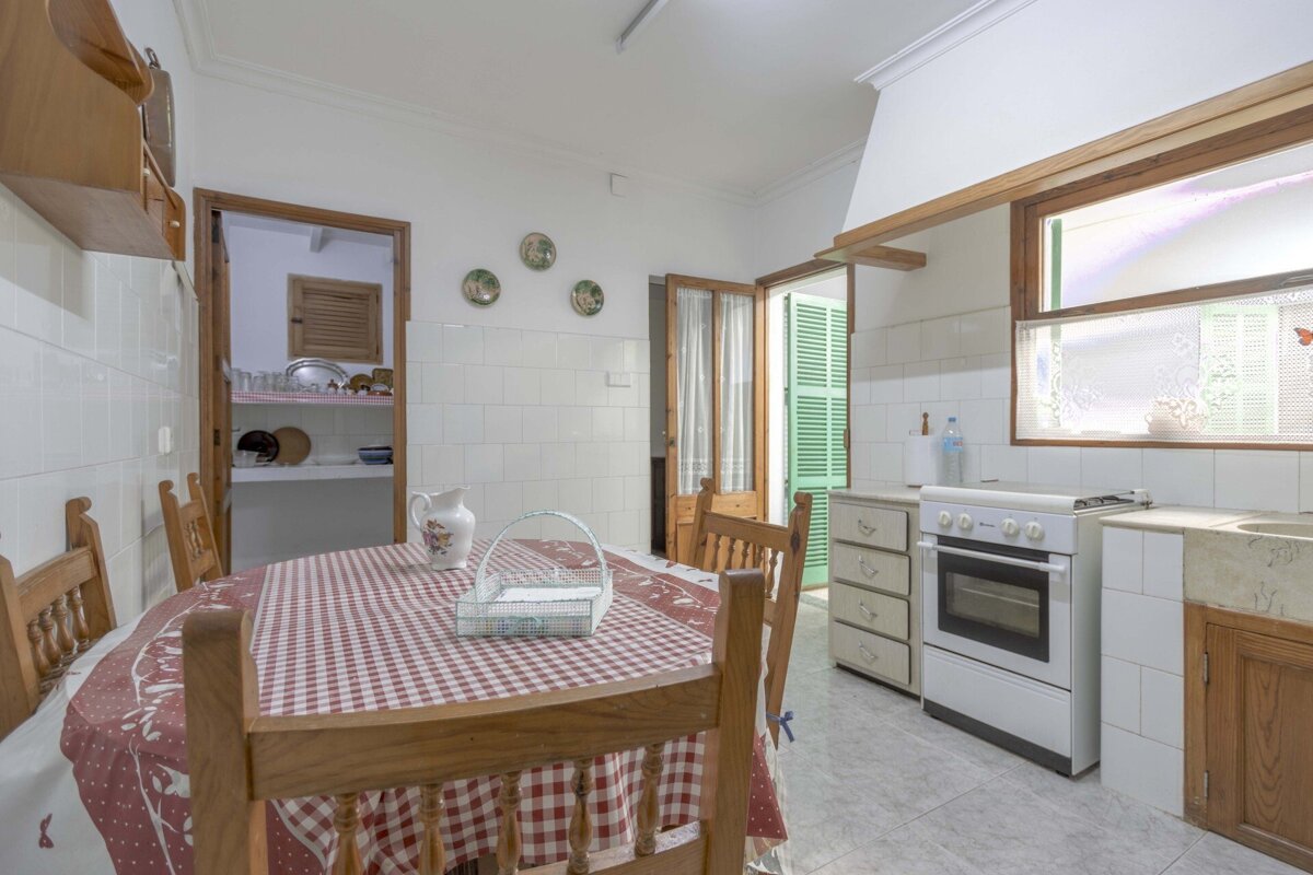 A kitchen with a table and chairs and a stove