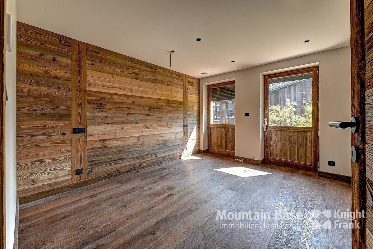 A room with wood paneled walls and a knight frank logo