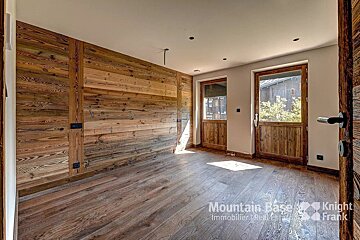 A room with wood paneled walls and a knight frank logo