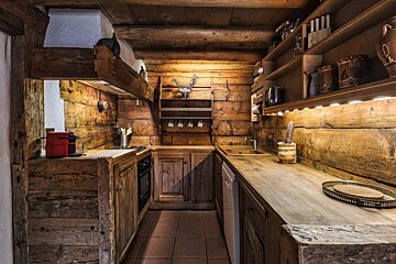 A kitchen with wooden cabinets and a coffee maker