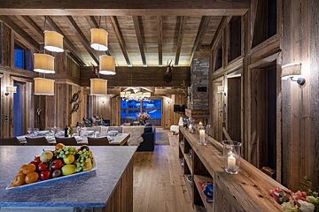 A bowl of fruit sits on a counter in a living room