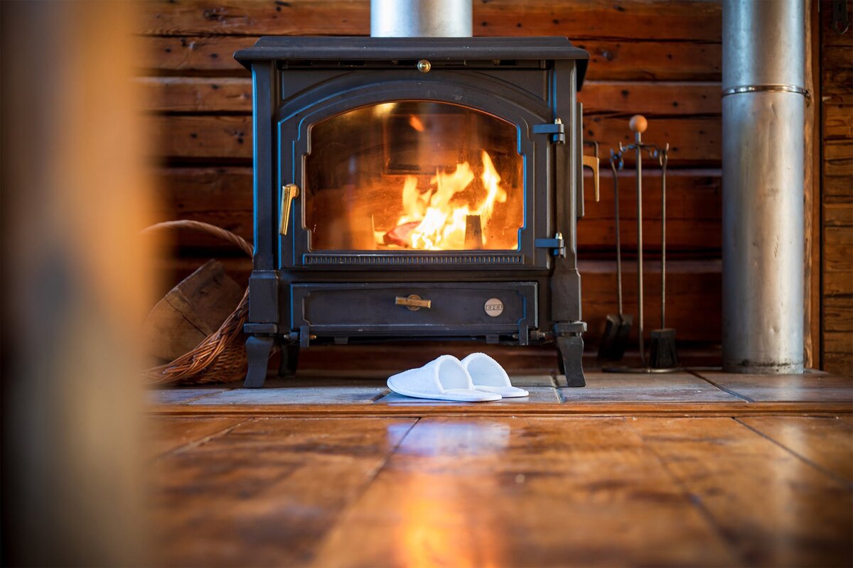 A wood burning stove with a label that says ' slippers ' on it