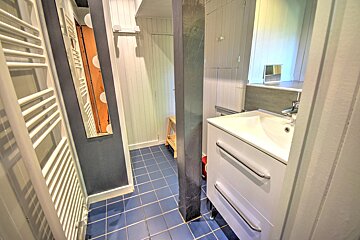A bathroom with a sink and a towel rack