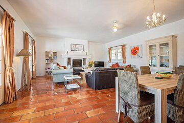 A living room with a table and chairs and a fireplace