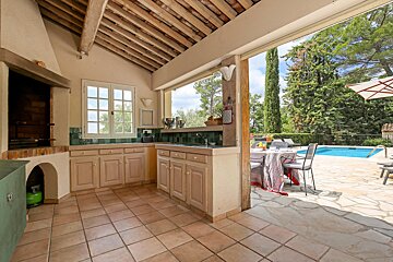 A kitchen with a sliding glass door leading to a pool