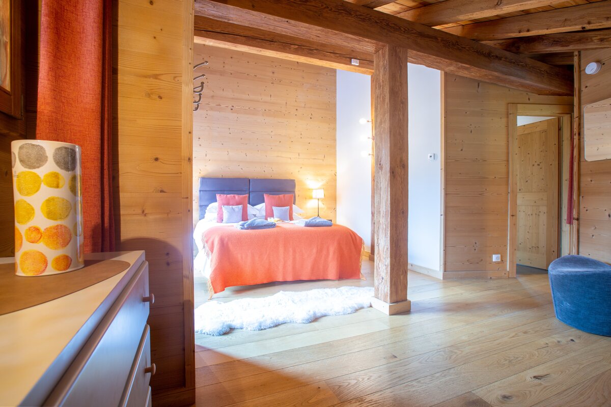 A bedroom with a bed and a lamp with circles on it