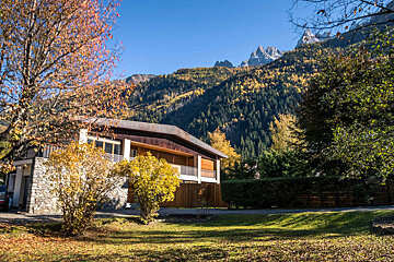 A house in the mountains with a mountain in the background