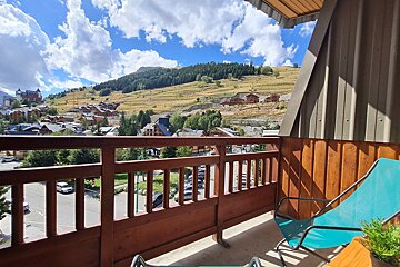 A balcony with a view of a mountain village