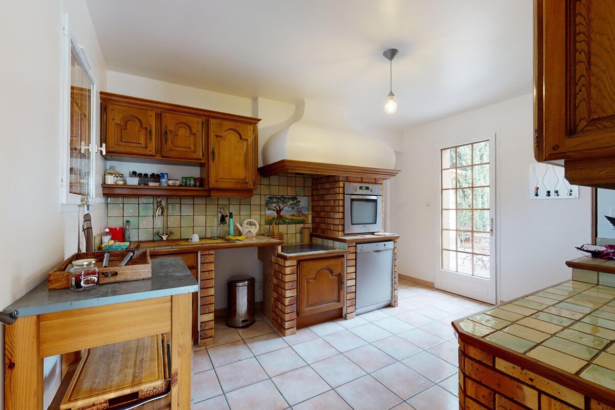 A kitchen with wooden cabinets and a stove top oven