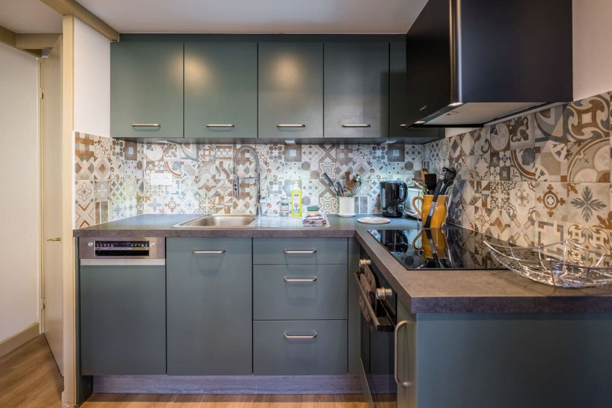 A kitchen with blue cabinets and a dishwasher that says ' lg ' on it