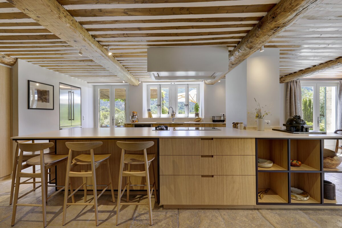 A kitchen with wooden cabinets and a large island