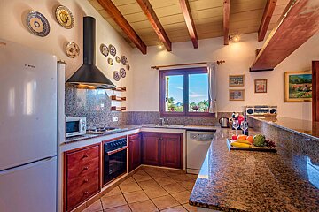 A kitchen with a bosch refrigerator and a microwave