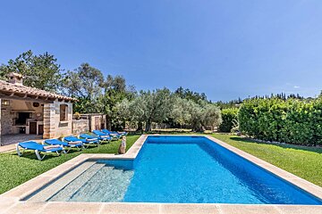 A large swimming pool with blue chairs around it