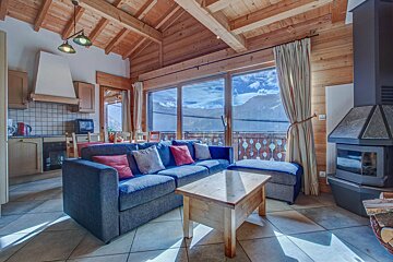 A living room with a blue couch and a fireplace