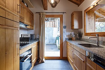A kitchen with wooden cabinets and a bosch dishwasher