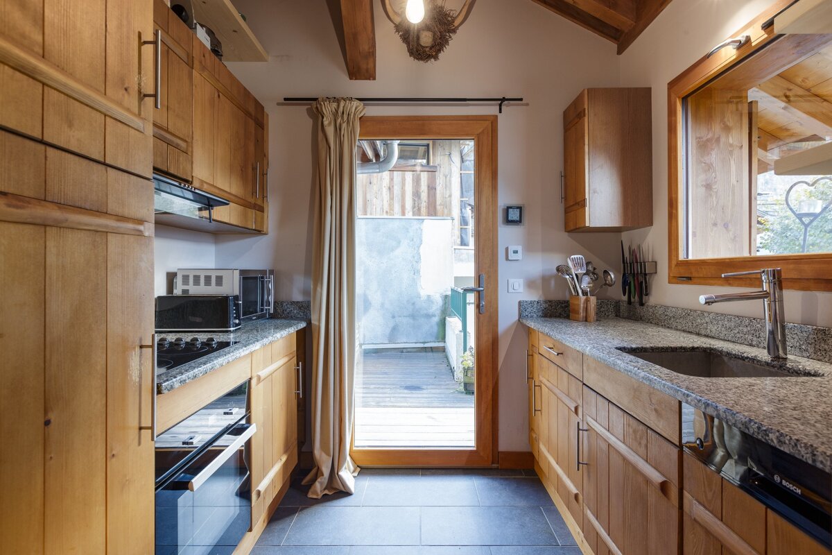 A kitchen with wooden cabinets and a bosch dishwasher
