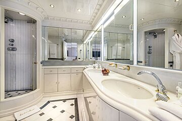 A bathroom with a sink and a towel that says escher