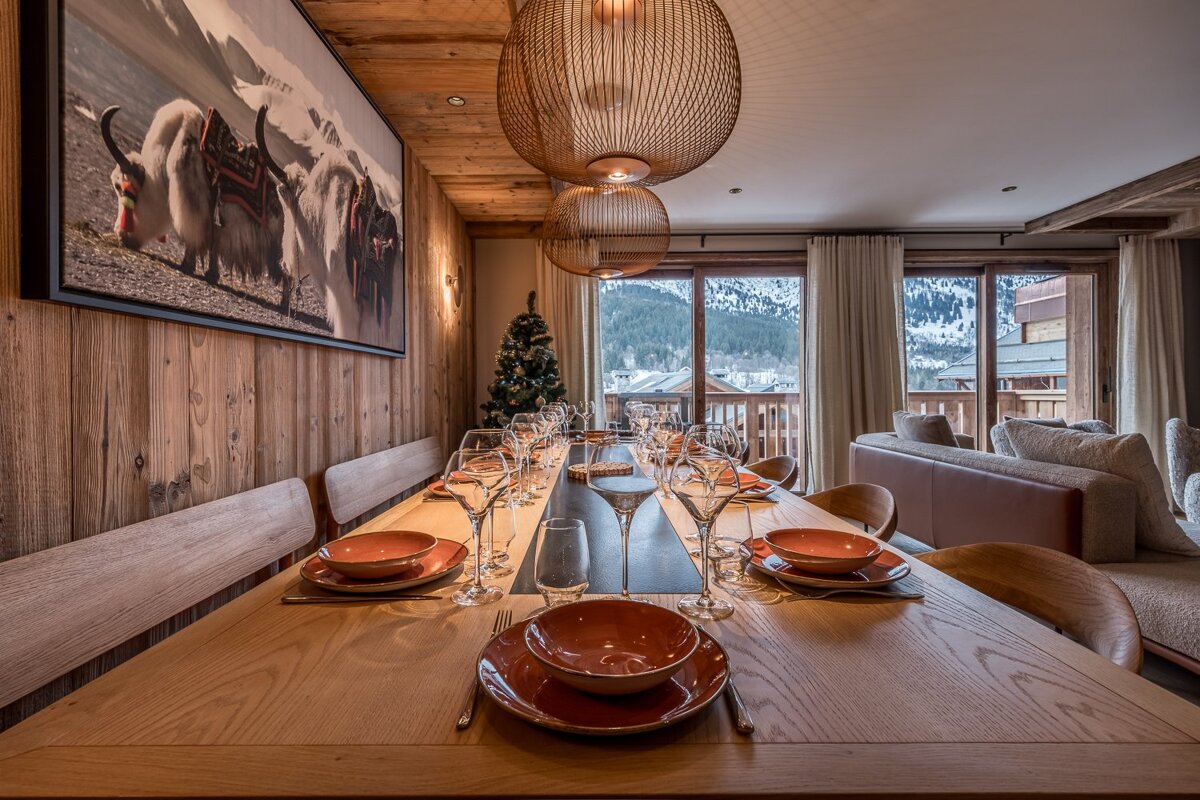 A dining room table with plates and glasses on it