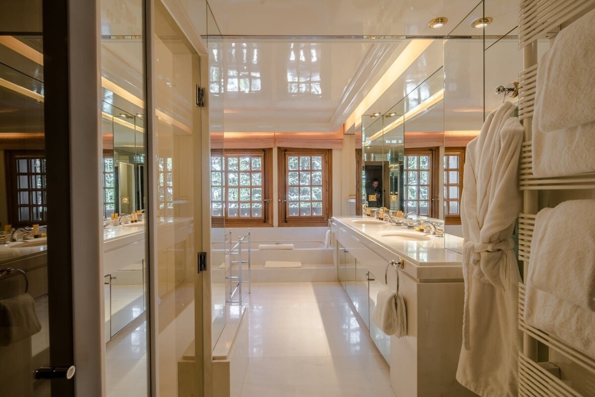 A bathroom with two sinks and a large window