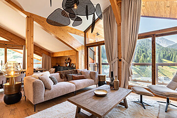 A living room with a couch a table and chairs