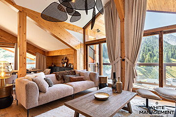 A living room with a couch a table and chairs