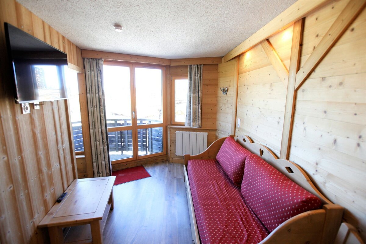 A living room with a couch and a flat screen tv