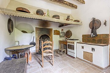 A kitchen with a table and chairs and a stove