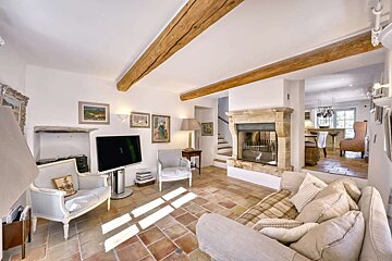 A living room with a fireplace and a flat screen tv