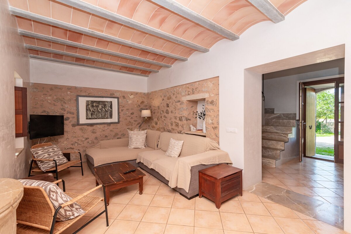 A living room with a couch and a picture on the wall