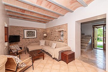 A living room with a couch and a picture on the wall