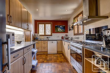 A kitchen with a picture on the wall that says alpine-property