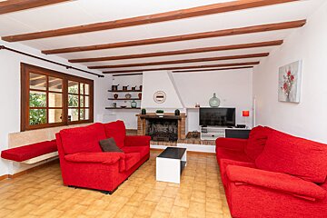 A living room with red couches and a fireplace
