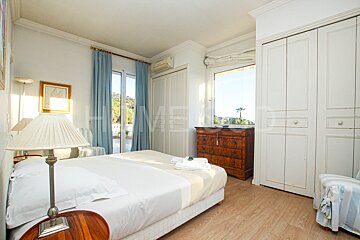 A bedroom with a large bed and a dresser with the word home on it