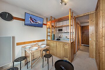 A flat screen tv shows a skier on the screen