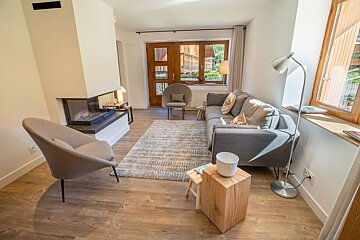 A living room with a couch a chair and a fireplace