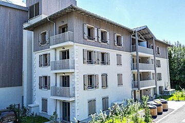 A building with a lot of windows and shutters on it