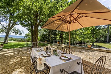A table with plates and glasses under an umbrella